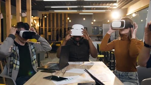 Young Business Team Wearing VR Virtual Reality Glasses in the Modern Office