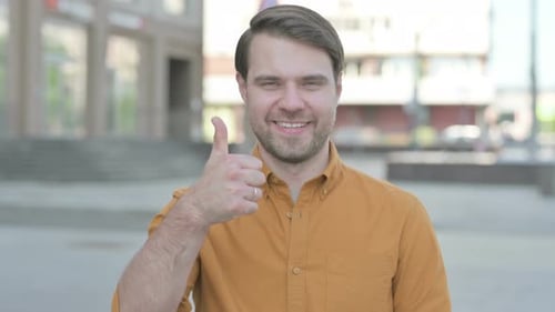 Man Giving Thumbs Up in the City