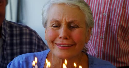 Smiling Senior Woman about to Blow out Candles