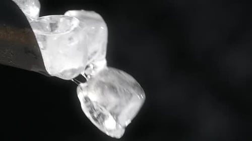 Ice Cubes Falling Slowly from Metal Scoop
