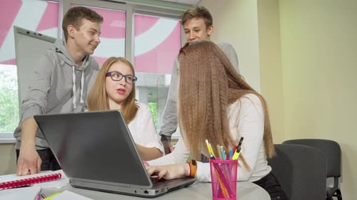 Group of Teenagers Discussing Assignment Studying Together at School