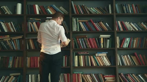 Man with Prosthesis in Hand Walk in Library Select Book