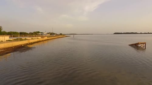 Aerial drone view of a man kiteboarding on a kite board