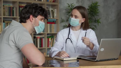 Medical Professional Discusses with Patient at the Office