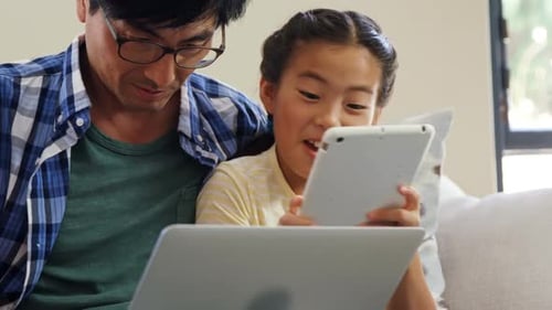 Family Enjoys Time Together Using Technology at Home