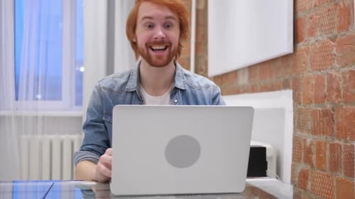 Young Adult Waving and Talking into Laptop Webcam