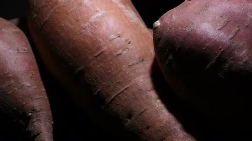 Macro Shot of Sweet Potatoes on Black Background