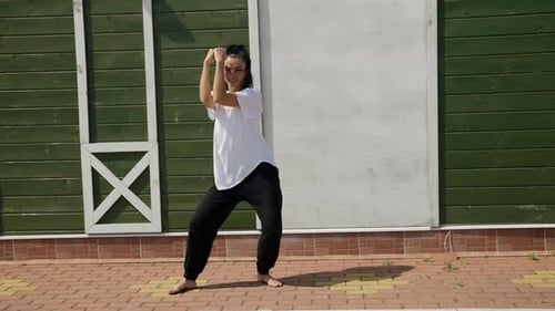 Hip Hop Female Dancer is Performing Dance on Street at Summer Time