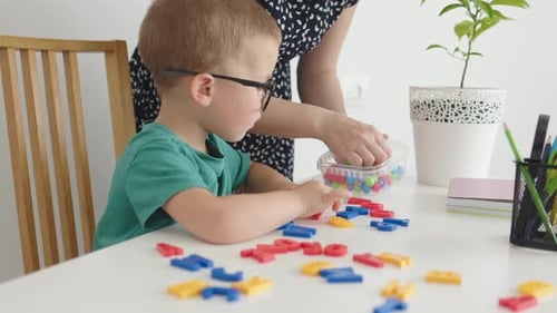 Child Learning Letters at Home with an Adult