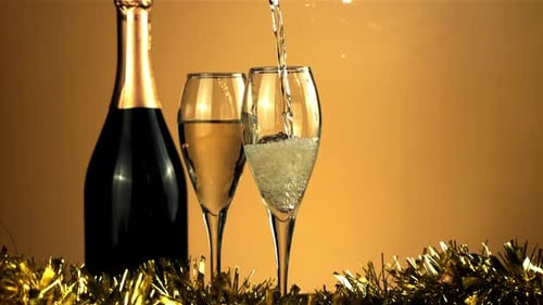 Champagne Pouring into Glasses with Festive Tinsel
