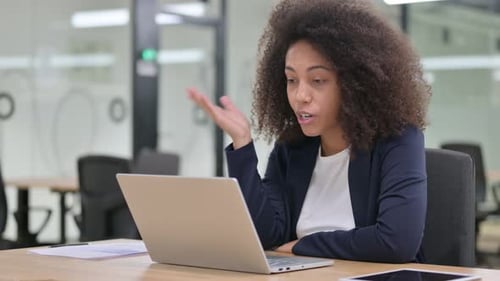 Smiling Woman Video Conferencing in Bright Modern Office