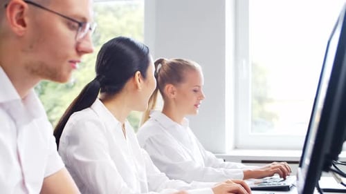 Diverse team of young professionals is working in the phone support office.