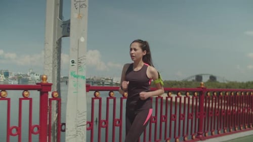 Fit Woman Jogger Running Looking at Sports Watch