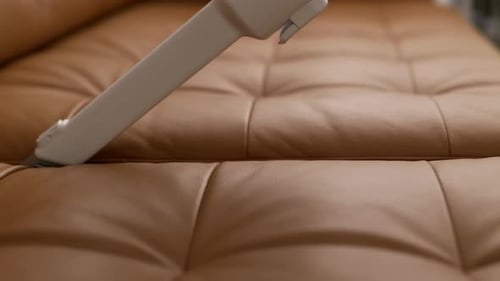 Cleaning Sofa with Vacuum Cleaner Between Folds