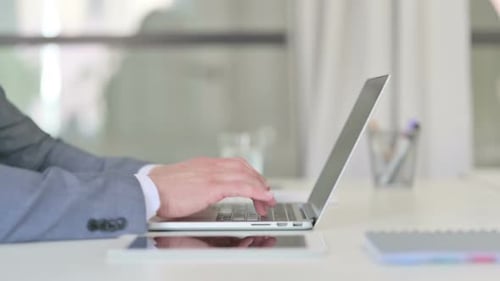 Close Up of Businessman Working on Laptop