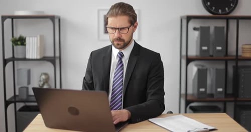 Man Doing Office Work on Laptop