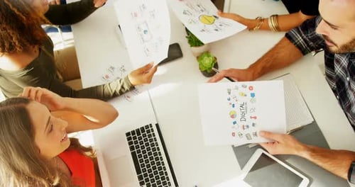 Team of executives interacting with each other while working in the office