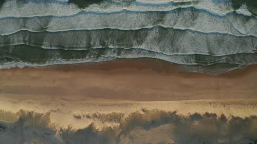 Landscape Wide View of Beautiful Beach with Dunes and Waves Crashing in White Foam, Aerial Overhead