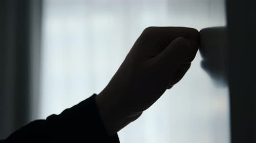 Man hand knocking on the door in a dark place.