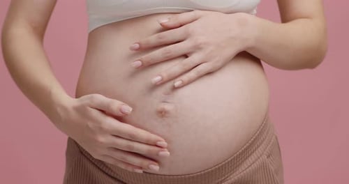 Close Up Shot of Pregnant Woman Stroking Her Big Belly Mother Waiting for Her Baby Slow Motion