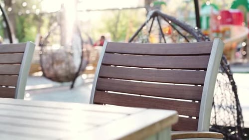 Empty Seat and Wooden Table in Outdoor Cafe
