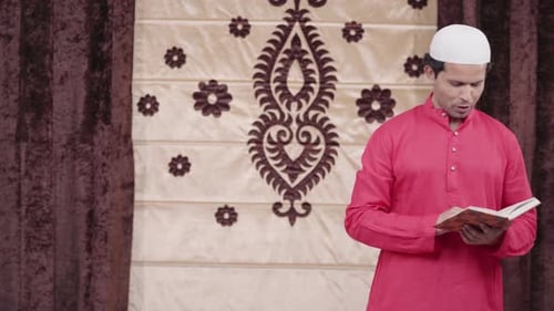 Man Reads from Religious Book Indoors