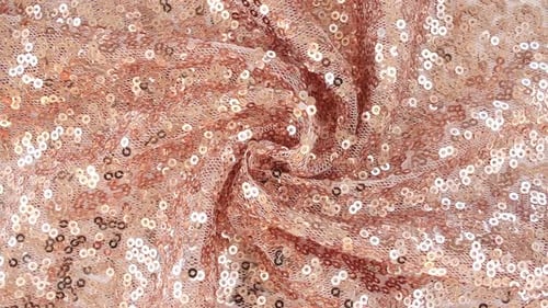 Tissu rose doré à paillettes