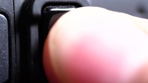 Finger Presses Record Button on Camera
