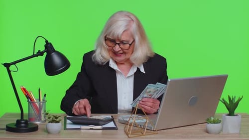 Senior Business Office Woman Accountant or Banker Making Money Cash Calculations Income Earnings