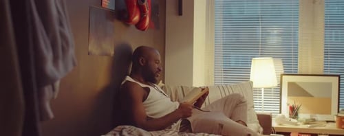 Man Relaxing Reading a Book Indoors