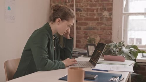 Businesswoman Working on Laptop in Office