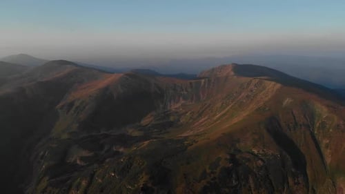 Top View of Mountain Peaks and Valleys Under Blue Sky