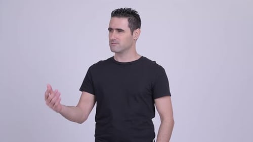 Man Expressing Confusion and Shrugging in Studio