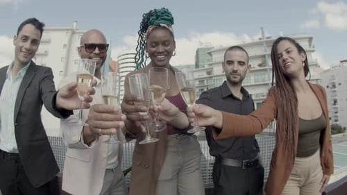 Front View of Happy Colleagues Clinking Glasses at Camera