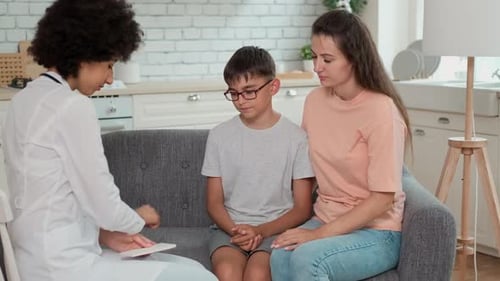 Doctor Consults with Child and Mother at Home