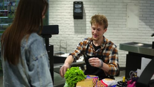 Handsome Bearded Young Male Scanning Groceries Checkout Products on the Counter
