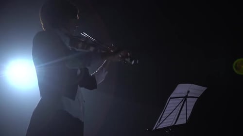 Violinist Performing in Dramatic Darkened Setting