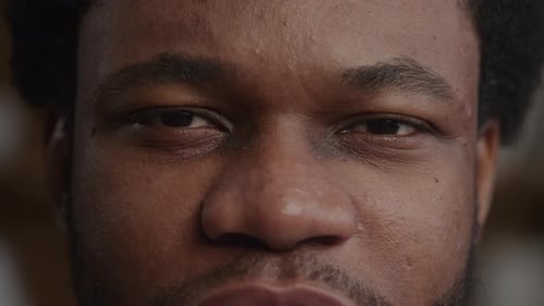 Extreme Close Up of an African American Man Eyes Looking at Camera While Talking