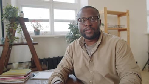 Man Presents Geometry Diagram at Desk