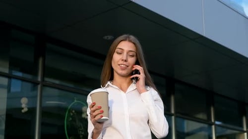 Woman Drinks Coffee and Talks on Phone