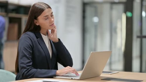 Tired Businesswoman with Neck Pain in Office