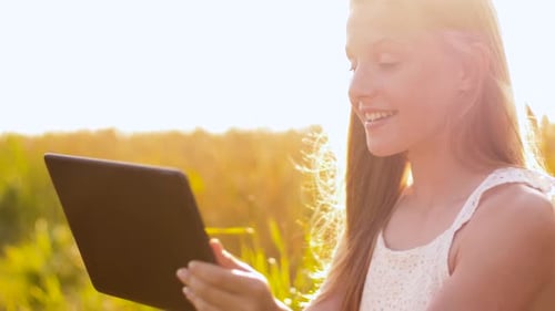 Smiling with Tablet Computer on Cereal Field