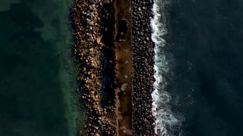 Top Down View on Breakwater a Far From the Beach
