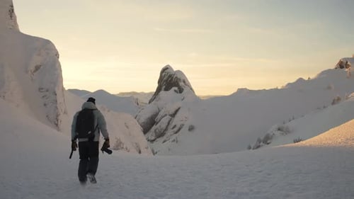 Landscape Photographer on the Mountain During Winter at Sunset