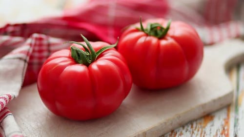 Two Fresh Eco Tomatoes Placed on White Wooden Cutting Board