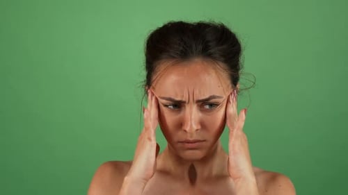 Woman Suffering From Headache in Studio