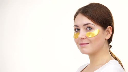 Woman With Gold Eye Patches Smiling