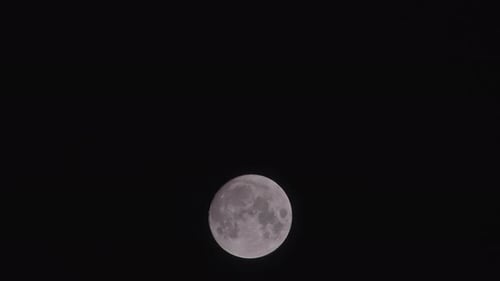 Full Moon Rising Across Dark Night Sky