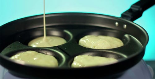 Pouring Pancake Batter into Frying Pan