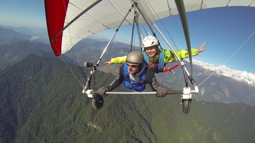 Adventurous Hang Gliding Flight over Green Mountains
